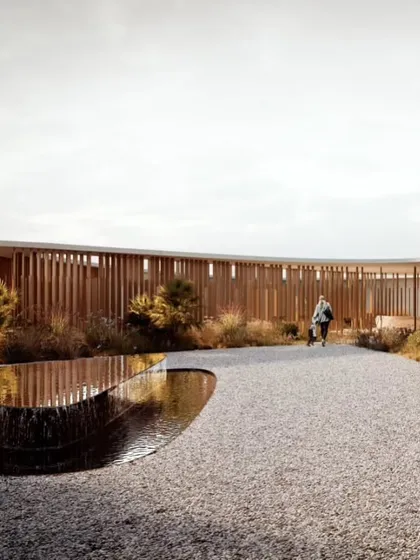 The entrance path to the villa is designed as a journey through a curated landscape, with water features and natural vegetation.