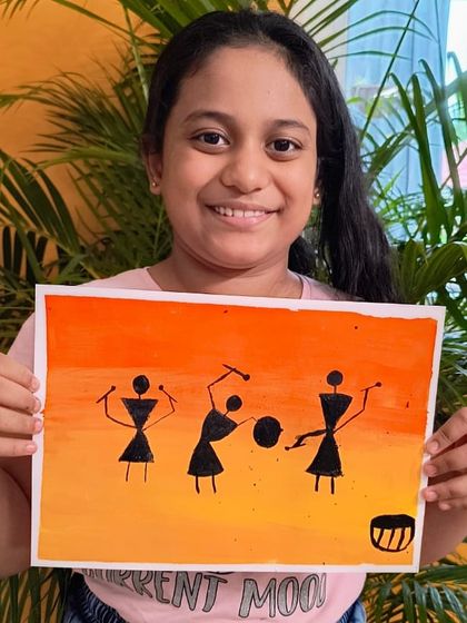 This student created a lively scene of Warli figures dancing and playing drums, using a warm, sunset-colored background.