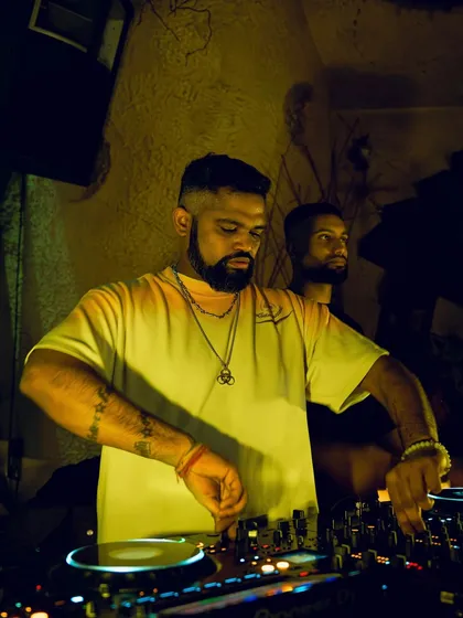 A focused shot of me at the decks at Baglami, with the warm, yellow lighting creating an inviting atmosphere.