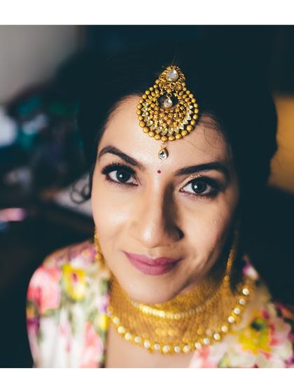 A beautiful close-up portrait of the bride, looking directly at the camera with a gentle smile. A simple yet powerful shot.