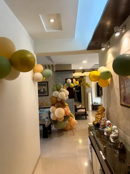 The balloon decorations continue down the hallway, leading the way to the main celebration area.