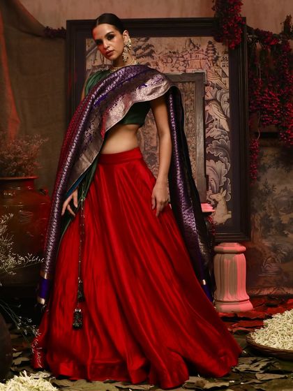 A modern take on ethnic wear, this shot for Soho Begum features a model in a red skirt and green blouse with a statement dupatta.