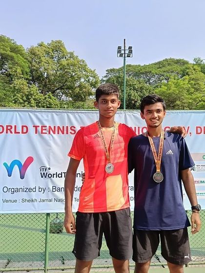 Naishik with his partner after securing the Doubles Runner-Up trophy at the 34th World Tennis Junior Tour event in Bangladesh.