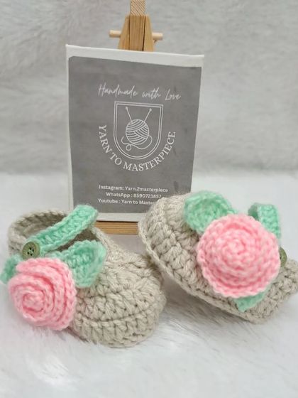 These beige and pink rose booties are a sweet and classic choice, with a button-closure strap for a secure fit.