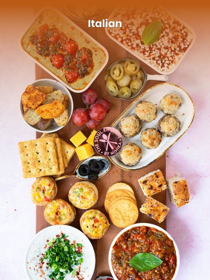 An Italian platter filled with crowd-pleasing starters like stuffed mushrooms and bruschetta, perfect for any party.