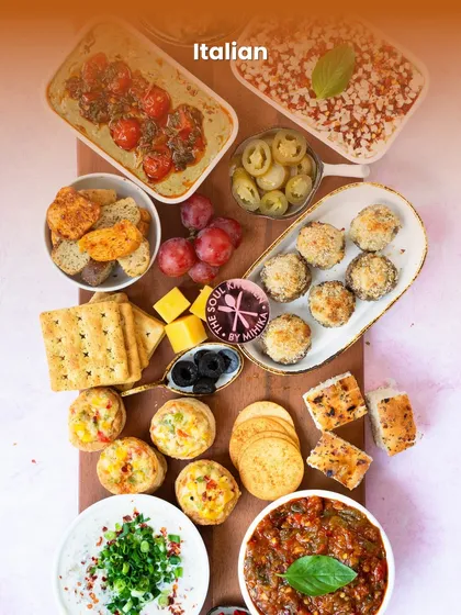 An Italian platter filled with crowd-pleasing starters like stuffed mushrooms and bruschetta, perfect for any party.