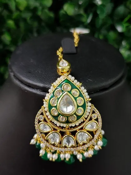 A similar design with green enamel, this maang tikka is perfect for a mehendi look or to match a green outfit.