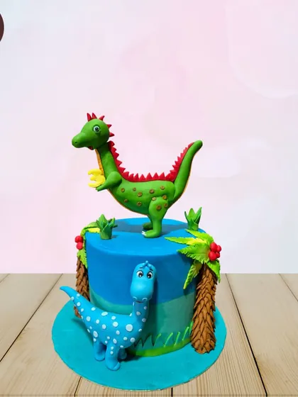 A vibrant dinosaur-themed cake with two friendly fondant dinosaurs in a prehistoric setting. Perfect for a dino-loving kid's birthday party.