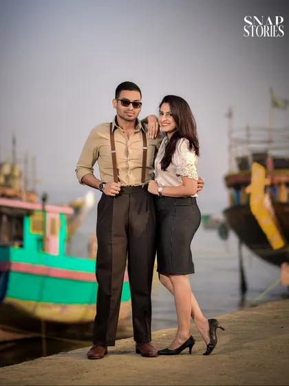 A stylishly posed portrait of a couple with a vintage vibe at a Mumbai dock, showcasing a unique and creative theme for a pre-wedding shoot.