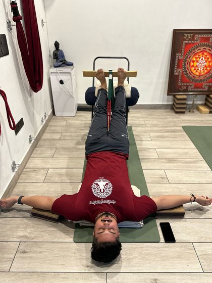 Restorative poses like this supported Viparita Karani calm the nervous system by reducing muscle tension and regulating breath. By elevating the legs, we also improve circulation, bringing the body into a state of deep rest.