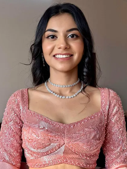 Soft glam never goes out of style. This look features glowing skin, subtle shimmer on the eyes, and a radiant smile, perfect for her pastel ensemble.