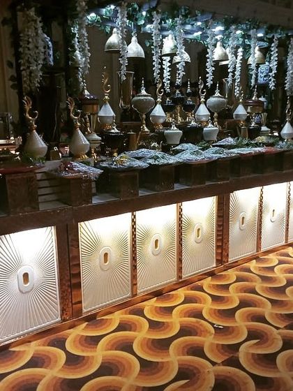 A grand, illuminated counter setup for a large wedding event. My team has the experience and equipment to execute high-end, large-scale event catering.