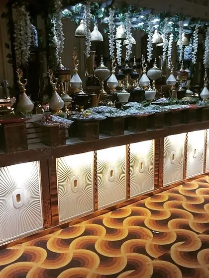 A grand, illuminated counter setup for a large wedding event. My team has the experience and equipment to execute high-end, large-scale event catering.