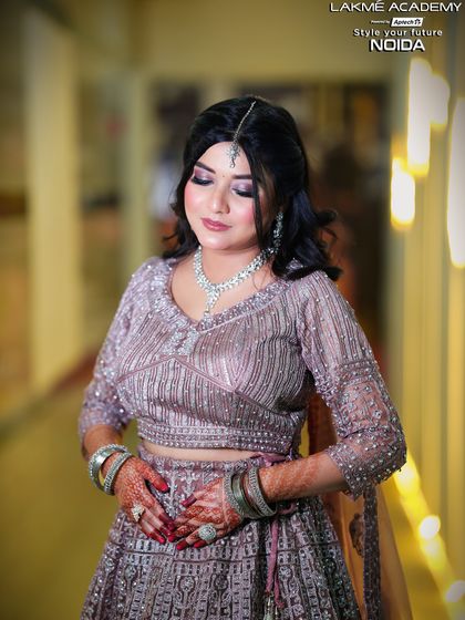 A close-up on the details of an engagement look. The intricate embroidery and the soft makeup application demonstrate the high level of skill our students achieve.