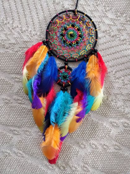Sometimes all you need is a little splash of color. This rainbow-feathered dreamcatcher is designed to brighten your car and your mood.