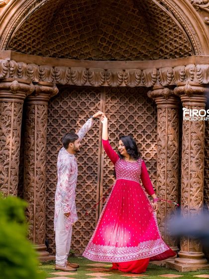 A dance in front of the grand carved doors, a perfect setting for capturing movement and joy in a traditional photoshoot.