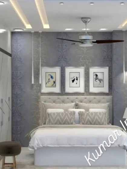 The feature wall behind the bed has a textured blue wallpaper and is flanked by elegant pendant lights, adding a touch of color and sophistication.