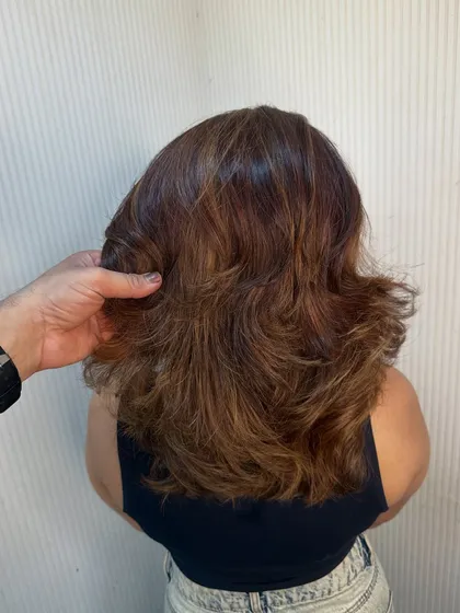 Our stylist showing the bounce and volume in this freshly cut and styled hair.