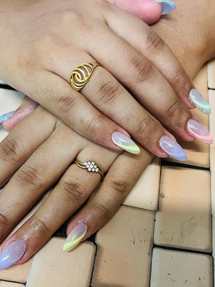 A beautiful pastel rainbow ombre on the tips of these long almond nails, perfect for spring or summer.