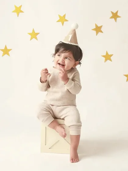 Looking up with pure wonder. This little boy, surrounded by stars, is the center of his own universe on his first birthday.