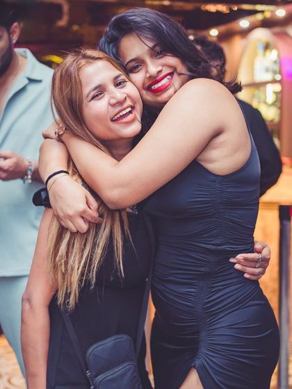 Friends embracing and smiling for the camera.