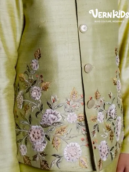 A detailed shot of the hand embroidery on our sage green Bundi set. The delicate floral pattern showcases the love and craftsmanship stitched into every piece.