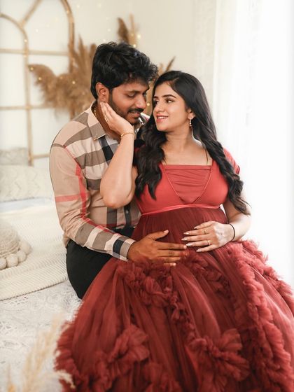 A playful and loving interaction between the couple. Her hand on his cheek and their shared gaze create a sweet, candid feel.