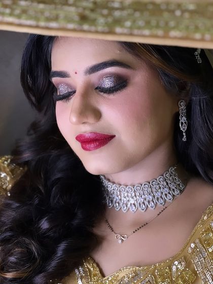 Beauty at its best. This reception look features dramatic glittery eyes and a classic red lip, a combination that never fails to impress.