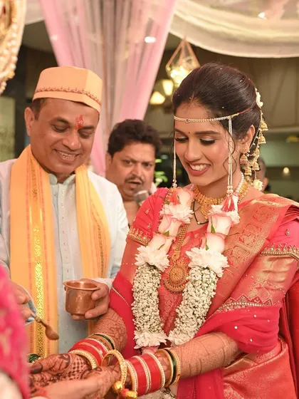 A heartwarming moment between the bride and her father during the kanyadaan ceremony. Her subtle makeup ensures her emotions are the focus.