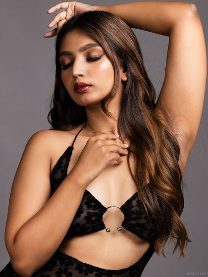 An emotive pose with the model's eyes closed, creating a soft and sensual mood.