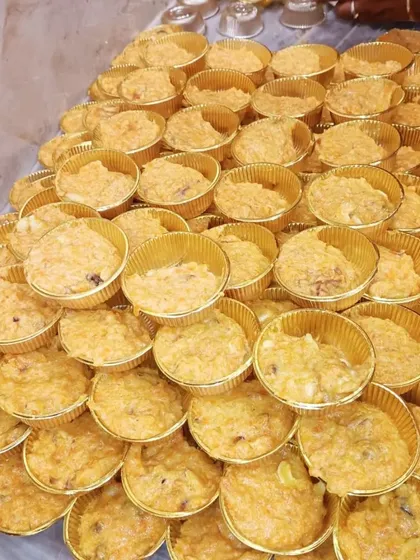 Gajar ka Halwa (carrot halwa) portioned into individual cups, ready to be served at an event.