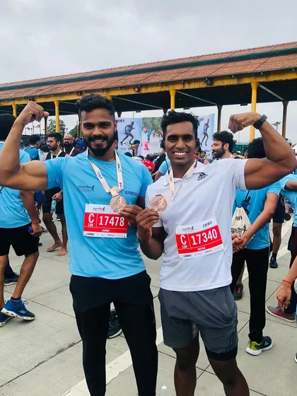 Celebrating a marathon finish with a fellow runner. Fitness is about achieving goals and building a strong community. We train to compete and to win.