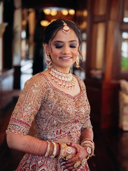 A happy, smiling portrait. This image captures the joy of the day, with her makeup looking fresh and radiant.