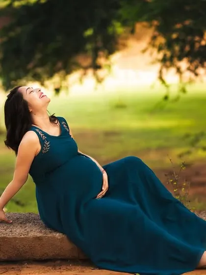 Soaking in a quiet moment of joy. Outdoor maternity sessions like this one use the beauty of nature and golden hour light to create a serene and timeless portrait of your pregnancy glow.