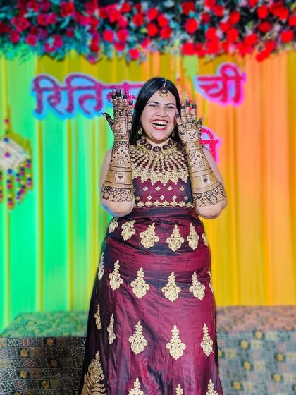 The pure joy of a mehendi ceremony! A happy bride laughing and showing off her elaborate henna, ready for her big day.