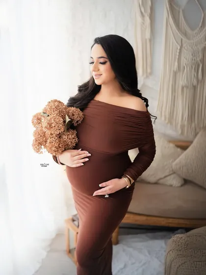 We can create a warm and cozy vibe for your shoot. This boho-inspired setup with earthy tones, a comfy bodycon dress, and a cute teddy bear prop is perfect for capturing sweet, tender moments.