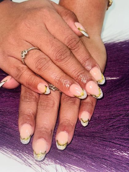 A creative take on the French tip, using chrome and glitter for the V-shaped tip. This design is modern, edgy, and perfect for a party.