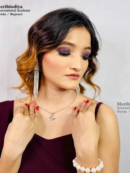 This image showcases a sophisticated cocktail party look with a deep purple smokey eye and soft, wavy hair, a versatile style for any evening event.