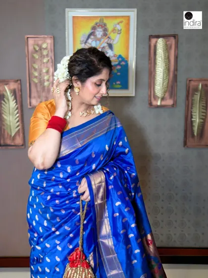 A candid moment from the Maa Chandraghanta shoot. The subject adjusts her hair, adorned with fresh flowers, offering a softer, more personal perspective of this traditional Maharashtrian look.