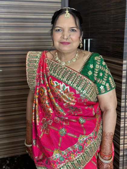 A vibrant and happy look for a family member, with makeup that complements her colorful traditional attire.
