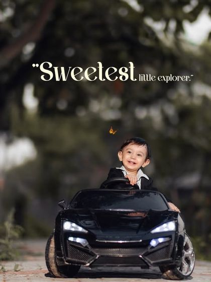 Sweetest little explorer. This happy boy enjoys a ride in his toy car, with a butterfly joining the adventure.