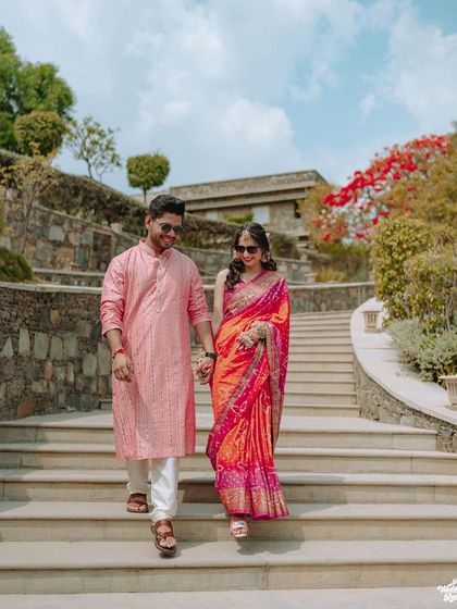 The couple makes a grand entrance down the stairs at the Ramada resort in Udaipur for their Haldi ceremony.