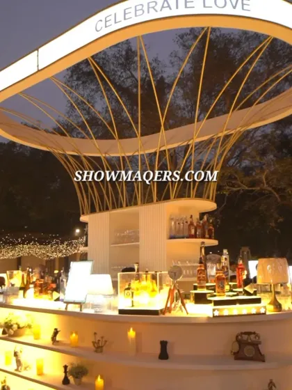 This custom designed, multi-tiered circular bar was the stunning centerpiece for an elegant Roka ceremony. We focus on creating functional yet artistic elements like this illuminated bar to elevate the guest experience and provide a central hub for celebration.