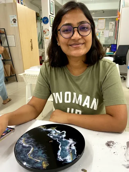 A participant with her finished marble-effect resin clock. The subtle blending of colors creates a beautiful and timeless piece.