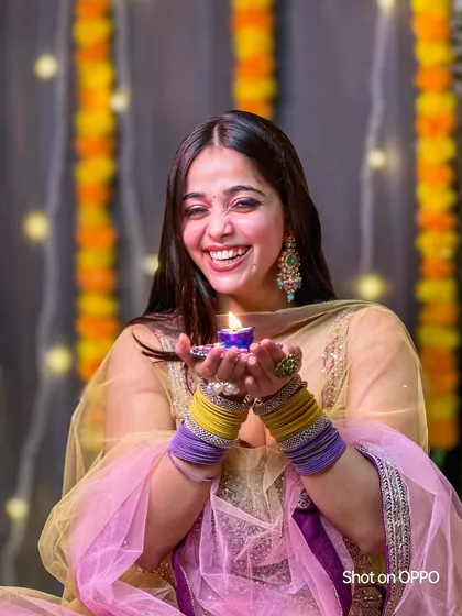 Another shot from the same Diwali series, this time capturing a moment of genuine laughter. The warm light and festive background create a joyful atmosphere.