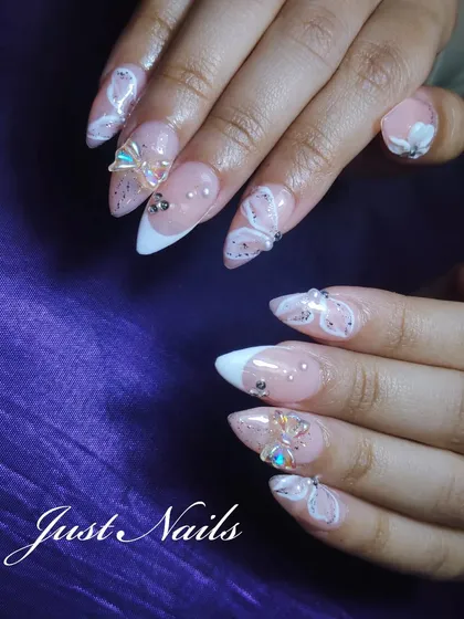 Showcasing my love for intricate, hand-painted details. These stiletto nail extensions feature delicate 3D butterfly and bow embellishments, white swirl patterns, and scattered gems over a glittery nude base with a French tip.