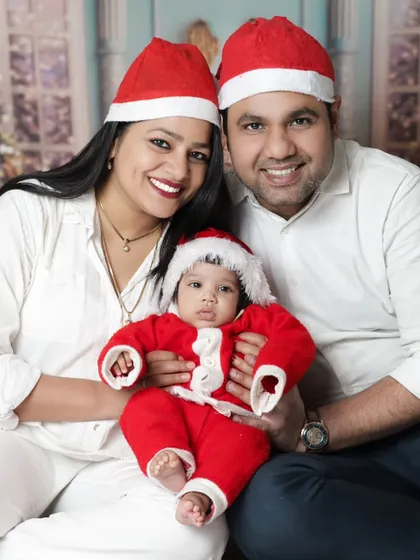 Christmas is for family. We love when parents join in for our festive mini-sessions. This beautiful family portrait captures the joy of their baby's first Christmas.