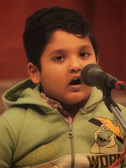 One of our 'little champs' completely absorbed in his performance. We provide a supportive environment for even our youngest students to confidently perform on stage.