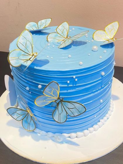 A different take on the blue butterfly cake, with a smooth finish and elegant butterfly placement.