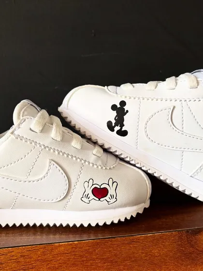 Sometimes simple is best. These kids' Nike Cortez shoes feature minimalist Mickey Mouse hands and silhouettes for a subtle touch of Disney magic.